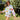 girl outside on a sunny day wearing a queen of sparkles' white sweatshirt set with colorful butterflies on it.